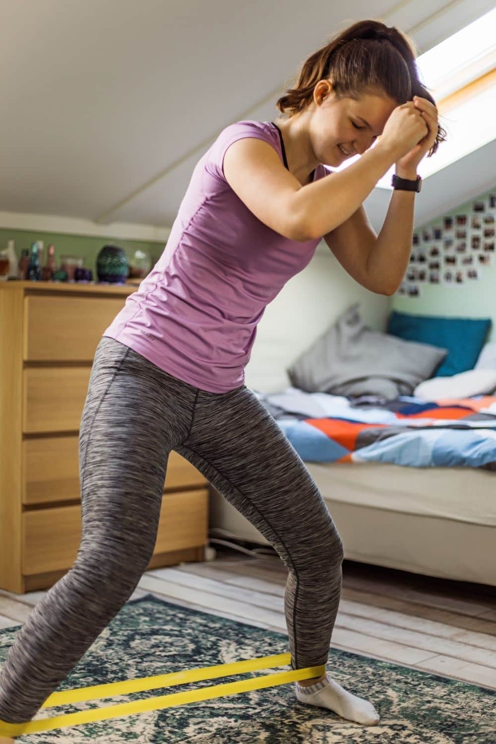 A woman works out at home in her bedroom