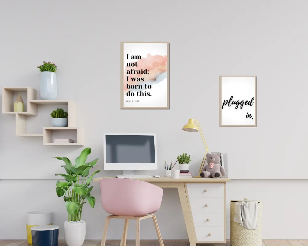 Desk with a plant, pink decorations, and motivational quote art to help you stay positive.