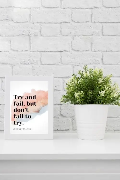 Framed motivational quote art on a desk