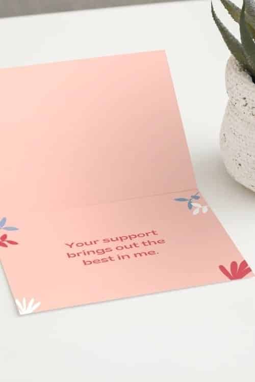 A pink thank you note sits on a table