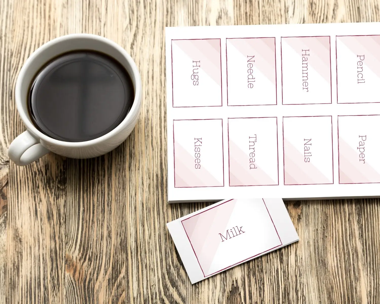 A sheet of find your pair cards sits next to a mug of coffee on a table